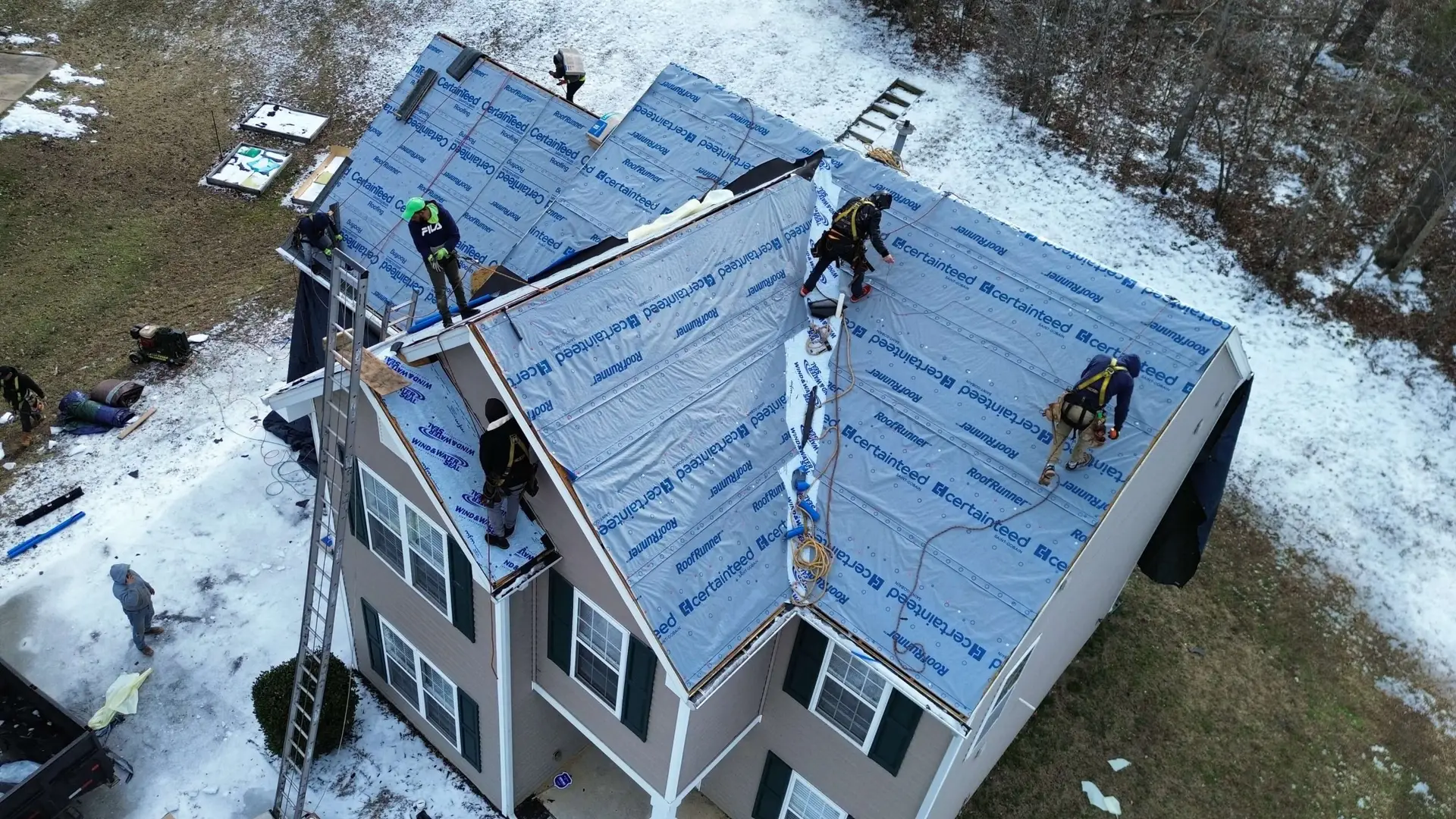Roofing crew installing synthetic underlayment during a roof replacement in the Oakdale area of Charlotte NC