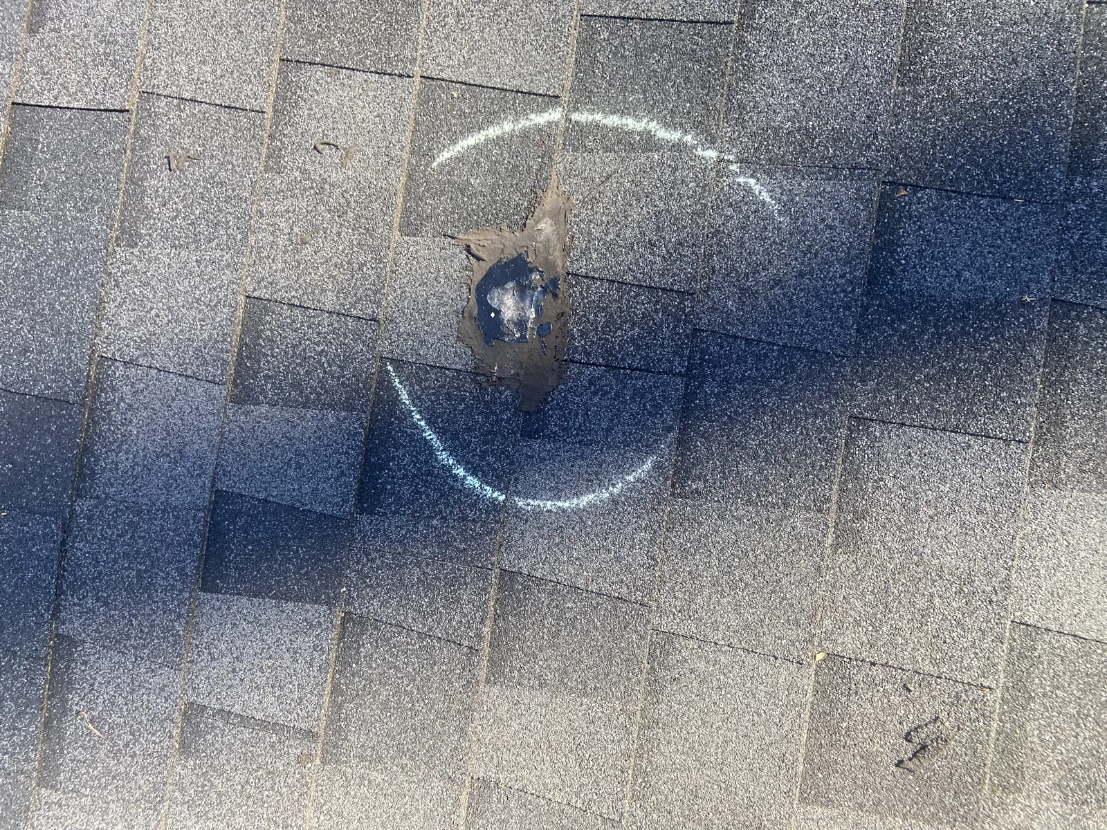 Hail damage chalk marked shingle hit